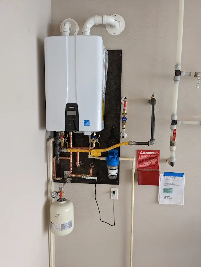 Professional plumber installing copper piping in a Livingston home